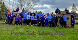 Trefoil Guild group outside with the words Bank on Track across the image