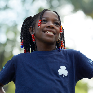 Girl in a Girl Guide uniform smiling confidently